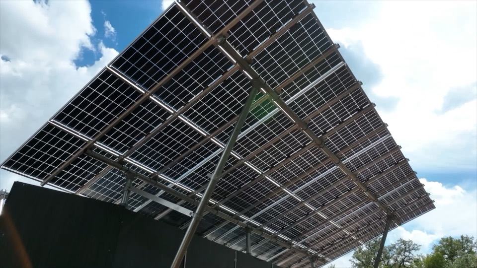 Looking up through the REV's bifacial solar canopy at a bright sky